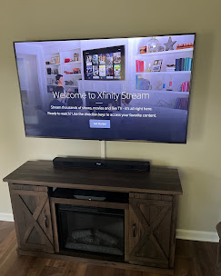 TV mounted above a farmhouse-style electric fireplace console